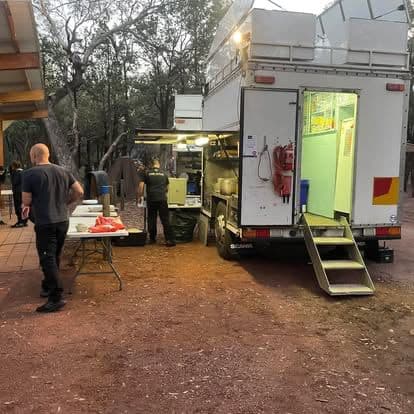 Chef Skills mobile kitchen serving a school camp in the Victorian bush at dusk.