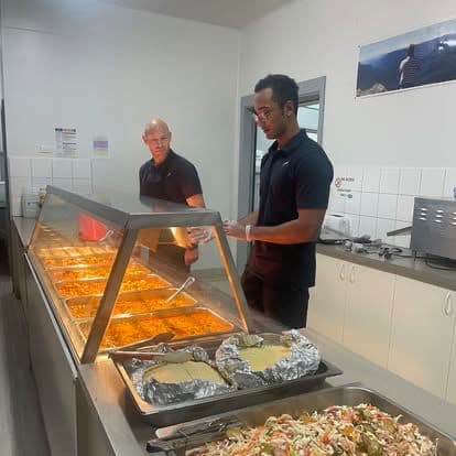 Chef Skills team at the buffet service line ready to plate meals.